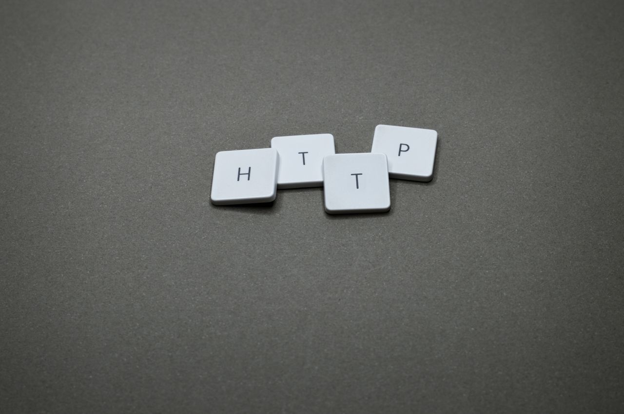 Home High-angle photo of keyboard tiles spelling HTTP on a dark background.