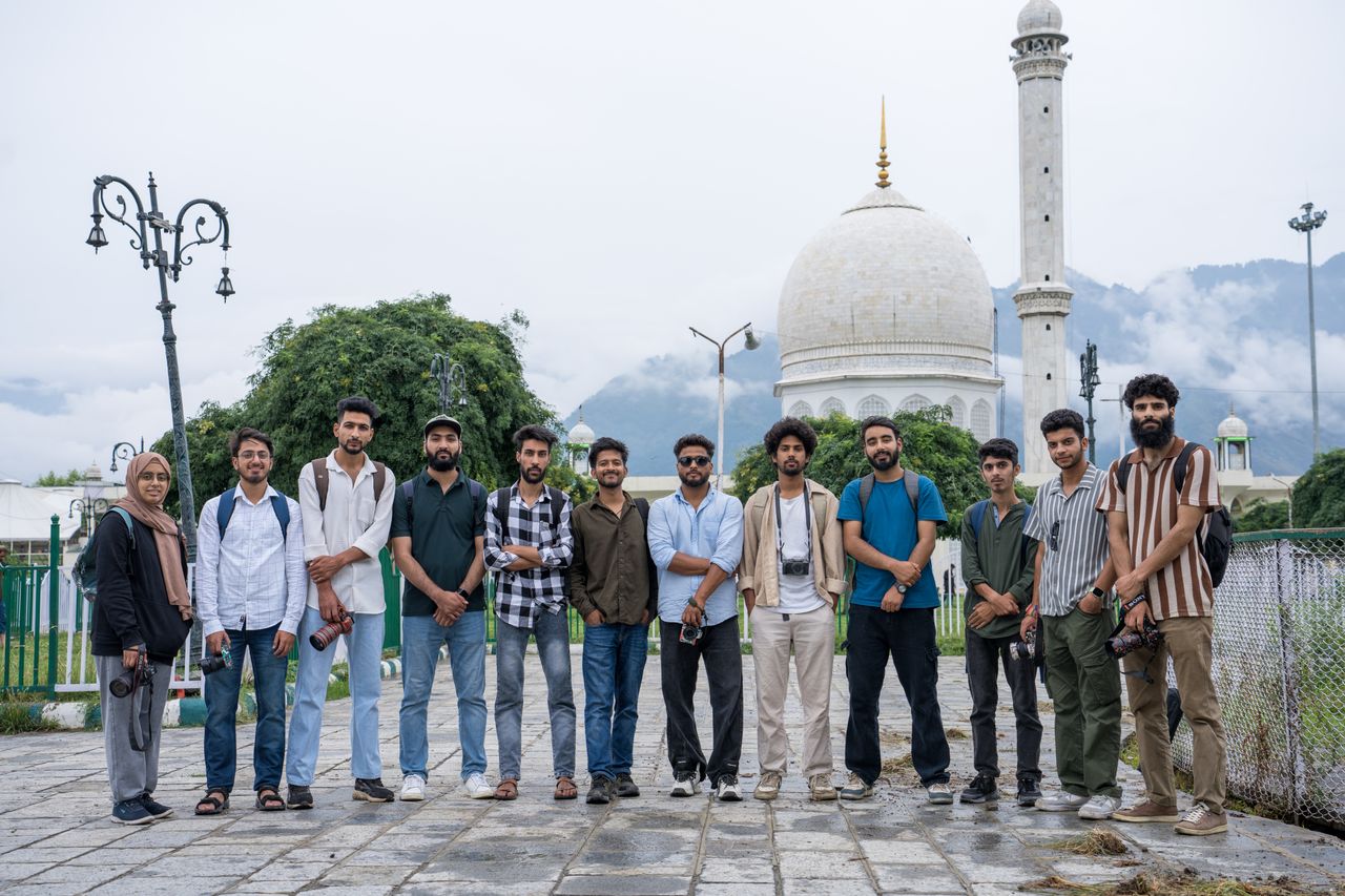 Crafting Captivating Headlines: Your awesome post title goes here A group of young adults in front of an iconic mosque in Srinagar, showcasing cultural diversity and friendship.