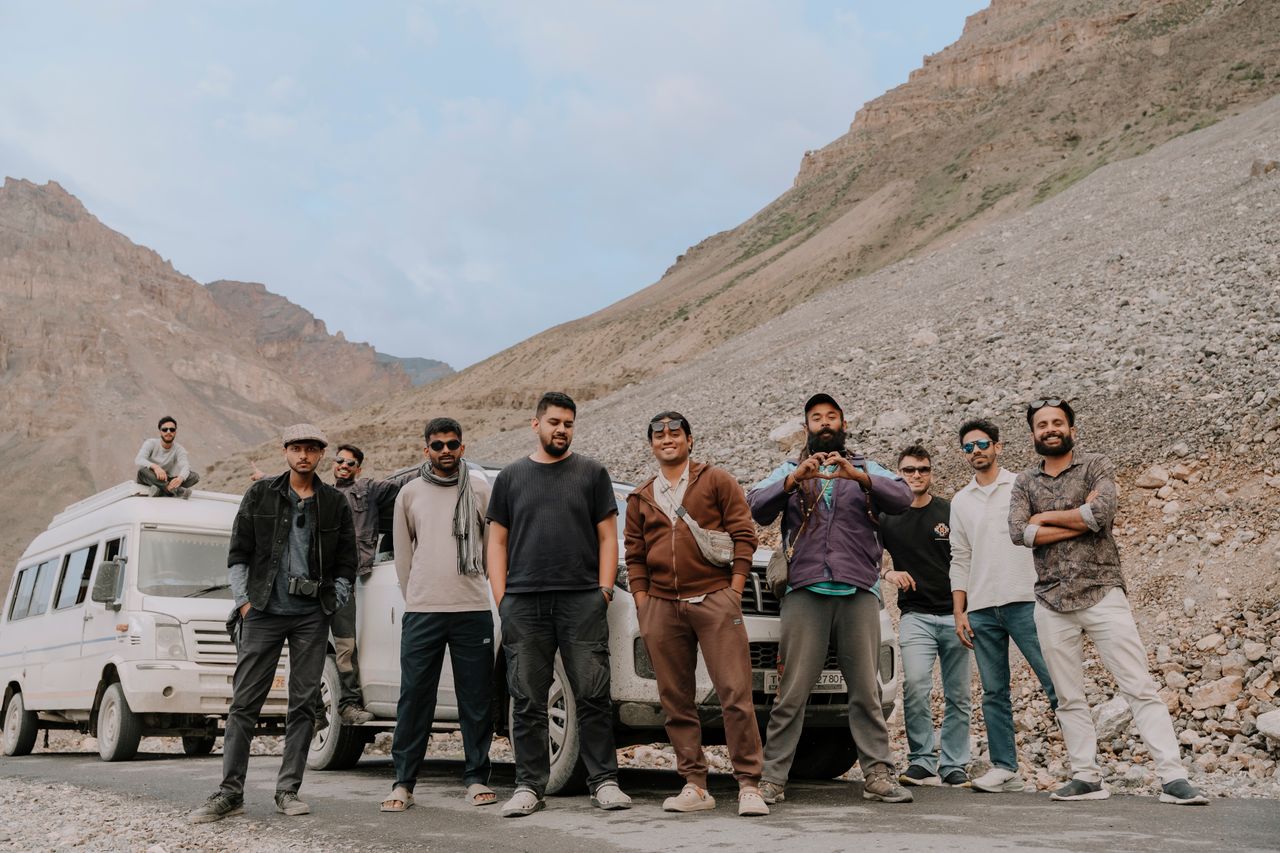 Mastering the First Impression: Your intriguing post title goes here A group of friends posing in front of a van on a scenic mountain road trip. Perfect for travel adventures.